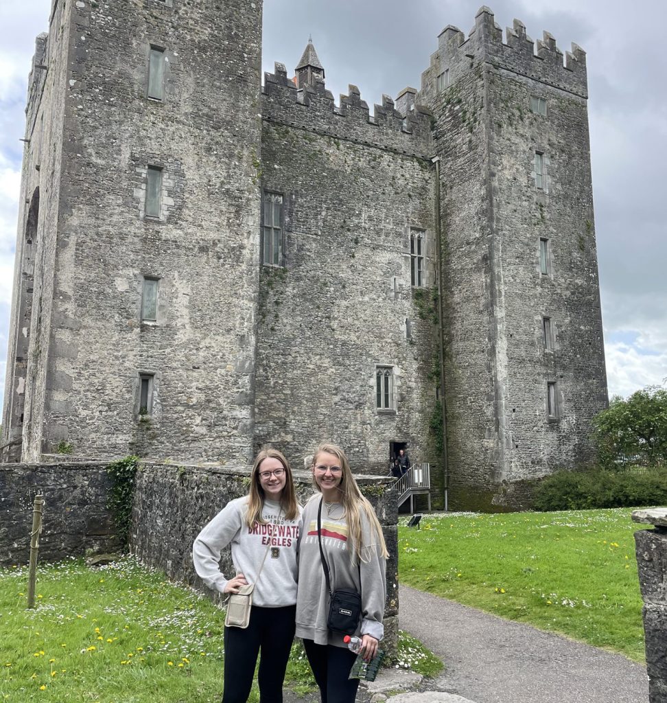 Two students standing in front of castle on study abroad trip